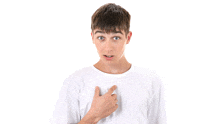 a young man in a white shirt is pointing at himself