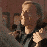 a man is giving a thumbs up to a woman while holding her hand .