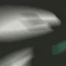a blurry picture of a person 's hand holding something