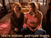 two women sitting on a bed with the words " we 're lesbian gay-type lovers " above them