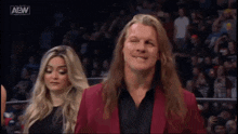 a man and a woman are watching a wrestling match .