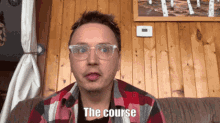 a man wearing glasses is sitting on a couch and says the course