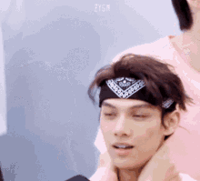 a close up of a man wearing a bandana around his head