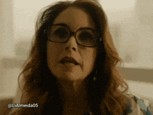a close up of a woman wearing glasses with the hashtag liaalmeida05