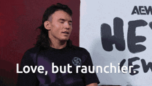 a man with a mullet is sitting in front of a sign that says " love but raunchier "