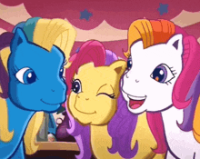 three ponies are posing for a picture and smiling for the camera