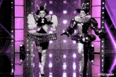 two clowns are dancing on a stage with purple lights behind them and the words tcyce tumblr on the bottom