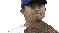 a man wearing a blue hat and white shirt is holding a baseball glove