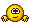 a pixel art smiley face with arms and legs is sitting on a white surface .