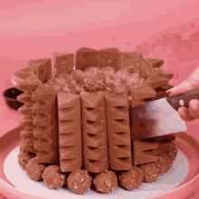 a person is cutting a cake with a spatula