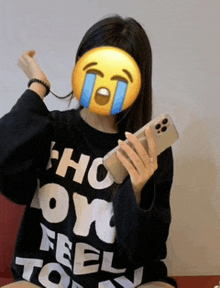 a woman wearing a black shirt that says " how i feel today " holds a cell phone