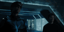 a man in a superhero costume stands in a dark room