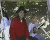 a man in a red shirt is sitting on a golf cart
