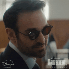 a close up of a man wearing sunglasses with daredevil born again on the bottom right