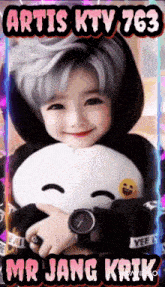 a girl with gray hair is holding a stuffed animal and smiling with the words artis ktv 763 mr jang krik below her