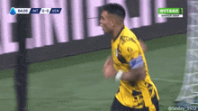 a soccer player celebrates after scoring a goal during a match