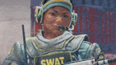 a woman in a swat uniform holds a rifle