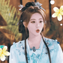 a woman in a blue and white dress with flowers around her