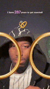 a man wearing a hat with a wedding ring on it and the words " i have 287 years to get married " above him