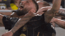a man with a tattoo on his arm is being lifted by a group of people
