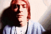 a close up of a man 's face with red hair .