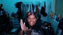 a man wearing a bandana and headphones is clapping