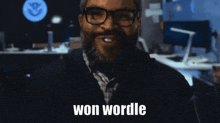 a man with glasses and a beard is smiling with the words won wordle below him