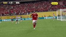 a soccer player celebrates a goal during a game sponsored by hisense and hisense tv