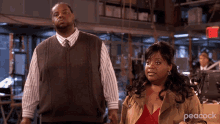 a man and a woman are standing next to each other in a room with peacock written on the bottom