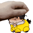 a hand is petting a cartoon character with glasses and a yellow jacket .