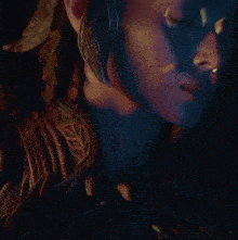 a close up of a woman 's face wearing a crown