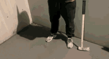 a person standing next to a hammer and a pair of adidas shoes