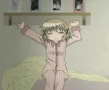 a girl in pajamas is stretching her arms in front of a shelf with pictures on it
