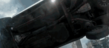 a car is turning over on its side in a city .