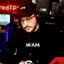a man wearing a black shirt that says miami