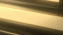 a close up of a metal surface with a light shining through