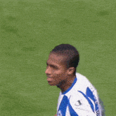 a blurry picture of a soccer player wearing a blue and white jersey with the letter a on it