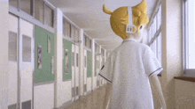 a person walking down a hallway with a sticker on their head that says " id "