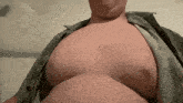 a man with a large belly is wearing a shirt