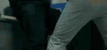 a close up of a person 's leg while standing next to another person 's leg .