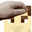 a close up of a person 's hand holding a piece of paper in front of a pixelated house .