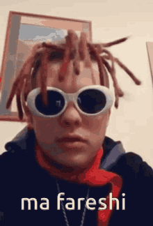 a man with dreadlocks wearing sunglasses and a red scarf says ma fareshi