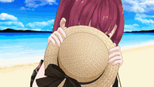 a girl covering her face with a straw hat