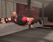 a bald man in a red shirt with the letter c on his chest is flying through the air
