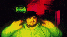 a man wearing headphones stands in front of a sign that says " tbeargames "