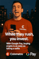 a man in a red sweater is holding a cell phone with the words " while they rush you invest "