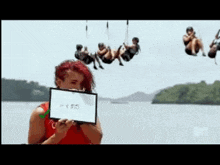 a woman with red hair is holding a check mark