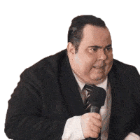 a man in a suit and tie holds a microphone in his hand
