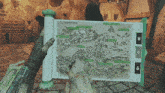 a person holding a map that says the forsaken lands on it