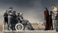 a man in a wheelchair is surrounded by a group of people standing in the desert .